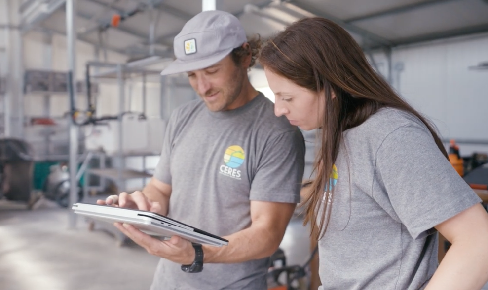 Two Ceres team members reviewing information together on a tablet.